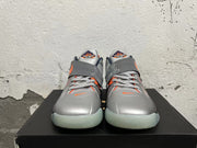 Front view showing silver Nike KD basketball shoes with orange details, laces, and a midfoot strap.