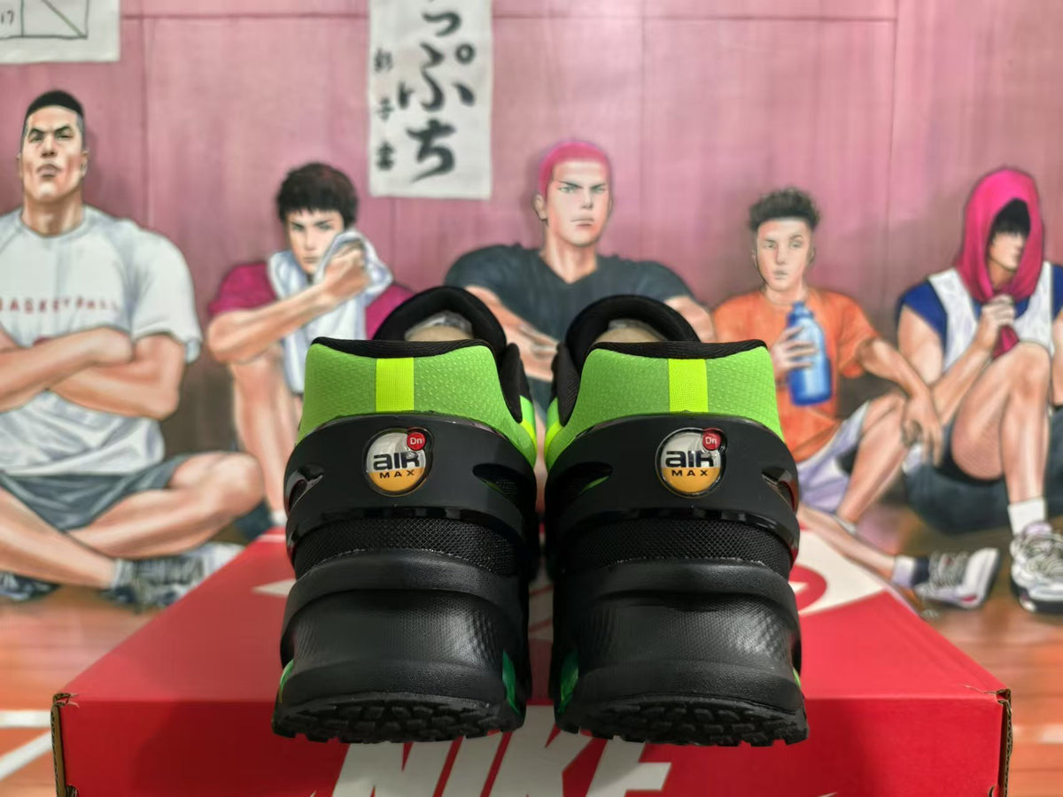 Rear view of black and bright green Nike Air Max sneakers showing the heel branding and outsole.