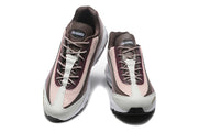 Top view of a pair of lace-up Nike sneakers with brown, pink, and light neutral panels.
