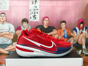 Side profile of a red Nike basketball shoe with white Swoosh, navy accents, and a speckled white outsole