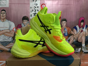 Angled view of lemon-yellow ASICS METARISE basketball shoes with black side branding, orange accents, and red pull tabs.