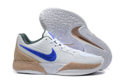 Two white Jordan sneakers shown from the side and outsole, highlighting the blue side accents and patterned rubber tread.