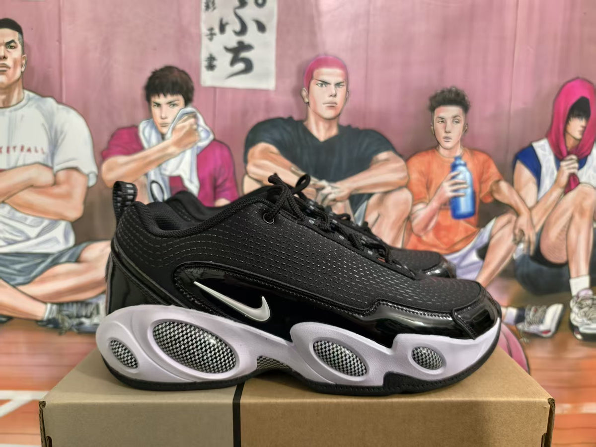 Side view of black and white Nike sneakers showing the textured upper, glossy side overlay, white Swoosh, and sculpted outsole.