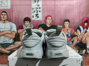 Rear view of the gray Nike sneakers showing padded heel collars, pull tabs, and heel branding.