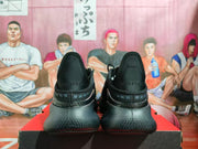 Rear view showing the padded heel sections and visible heel text on the black sneakers.