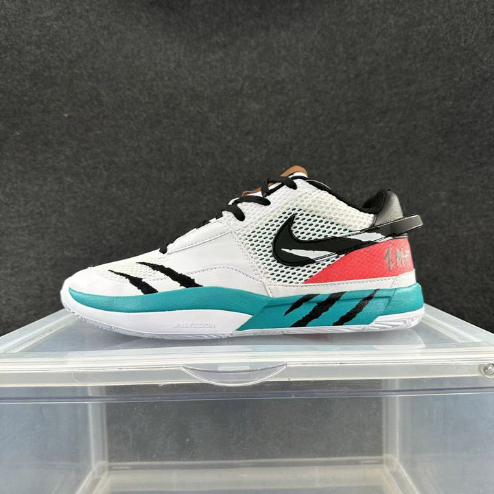 White, black, and turquoise Nike low-top sneaker with mesh-look panels and a pink-red heel accent.