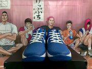 Front view of a pair of blue basketball sneakers with white laces and textured uppers.