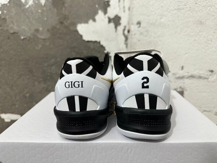 Rear view of black and white Nike Kobe shoes with GIGI and number 2 heel details