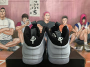 Rear view of the sneakers showing black heel panels and white shell sections.