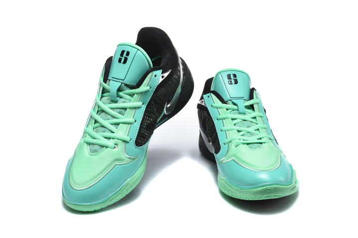 Pair of black and bright green Nike Kobe basketball shoes shown from the front