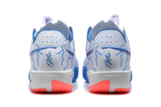 Rear view of the white and blue sneakers showing perforated collars, blue detailing, and coral outsole sections.