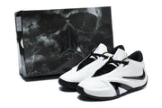 White and black Nike Kobe basketball shoes beside a branded shoe box.