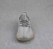 Front view showing the gray woven-looking upper, laces, and coral side accents.