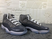 Pair of cool grey and black high-top sneakers shown from the side with white laces and white midsoles.