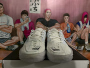 Front view showing the laces, grid-patterned toe panels, and Nike logos.