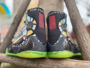 Rear view of the Nike Kobe 9 All-Star shoes, showing patterned panels and lime-green outsoles
