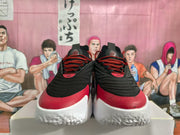 Front view showing red-and-black laces, black uppers, and white midsoles.