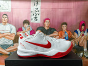 Side view of a white Nike basketball shoe with a red Swoosh and red outsole.