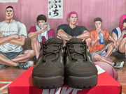Front view of dark brown Nike sneakers with lace-up closures
