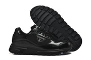 Black lace-up sneakers shown with a close view of the ridged outsole