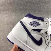 Close-up of the side profile showing the Jordan winged emblem, purple Swoosh, and layered white panels.