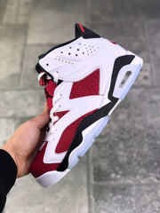 Side view highlighting the perforated white upper, red panels, black trim, and translucent outsole.