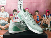 Angled view of a pair of mint-green and gray Nike basketball shoes
