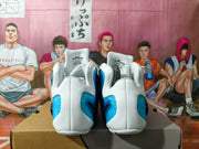 Rear view of the white and blue Nike basketball sneakers, showing the heel panels and tongue labels.