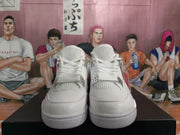 Front view of a pair of white high-top sneakers showing the laces, mesh tongues, and textured toe areas.