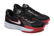 Close angled view of the pair showing black uppers, red stitching, white Swooshes, white midsoles, and red forefoot outsoles.