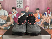 Front view of Nike GT Cut shoes showing striped toes and red details