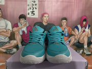 Front view of teal basketball sneakers showing textured toe panels, teal laces, and white soles.