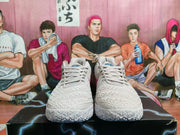 Front view of light pink lace-up basketball shoes with textured uppers