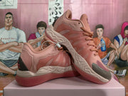 Angled view showing the pink sneakers’ side detailing, sculpted sole, and patterned outsole.