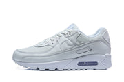 Side profile of a white Nike Air Max 90 sneaker.
