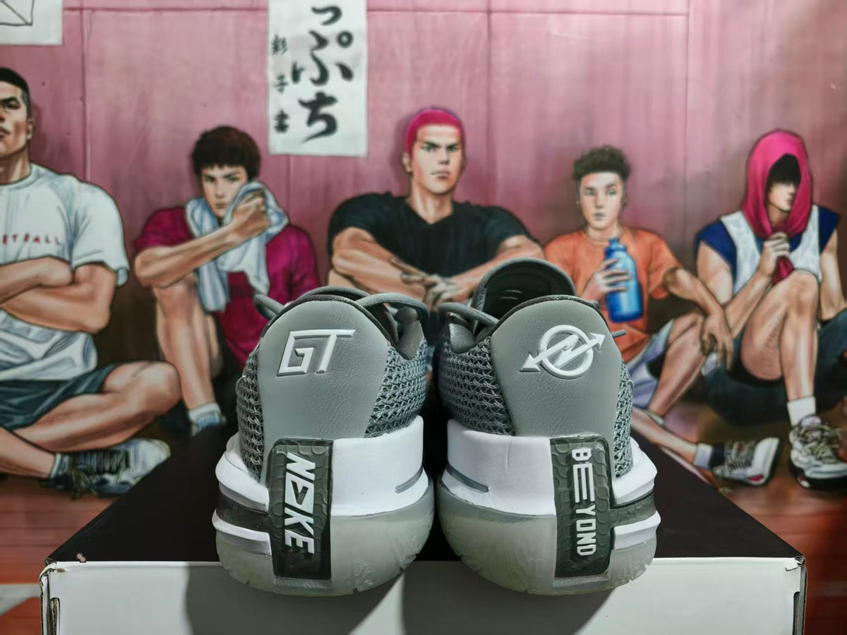 Rear view of gray Nike basketball shoes with white midsoles and contrasting heel graphics