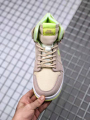 Top-down view of the sneaker showing the padded tongue, tonal laces, beige toe panel, and bright collar lining.