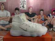 Side view of a white Nike high-top sneaker with ankle strap, textured upper, and sculpted sole