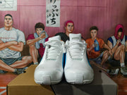 Front view of white and blue Nike basketball shoes showing the laces and toe design