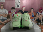 Front view of the mint green Jordan basketball sneakers showing matching laces, padded tongues, red tongue accents, and black toe-outsole details.