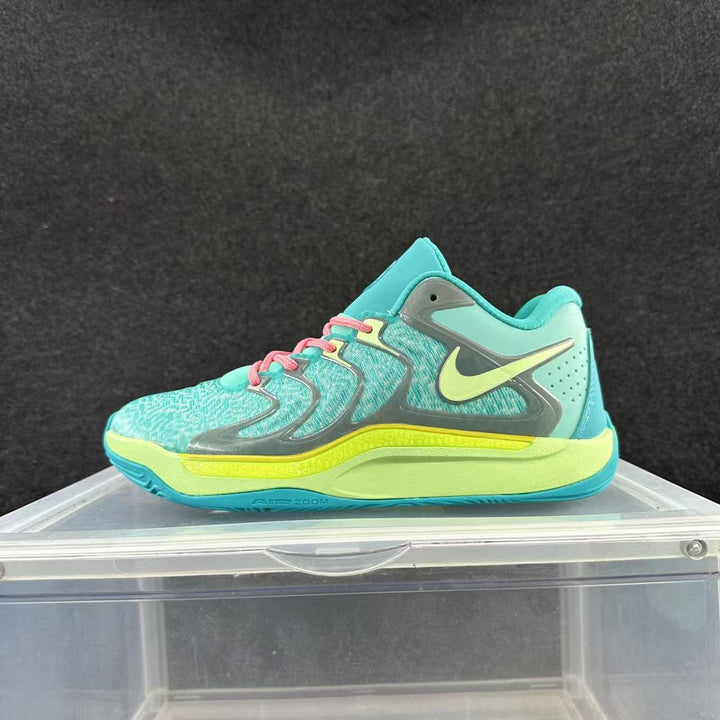 Side view of turquoise Nike basketball shoes with a bright green Swoosh and midsole accents, gray overlays, and pink laces.