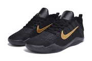 Pair of black and gold low-top basketball shoes, front three-quarter view