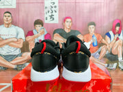 Rear view showing the black heel panels, red pull tabs, white midsoles, and red outsoles.