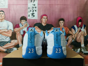 Rear view of white and blue Jordan sneakers showing JORDAN heel tabs and the number 23 detail.