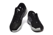 Pair of black and white Jordan basketball sneakers shown from the front and side.