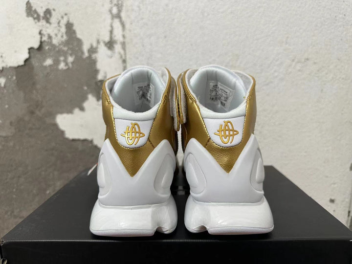 Rear view of white and metallic-gold Nike Zoom 2K5 basketball shoes.