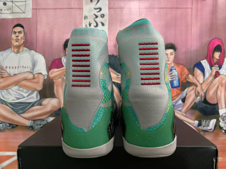 Rear view of gray and green high-top basketball shoes with red heel details