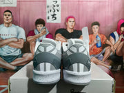 Rear view of the sneakers showing dark gray heel sections, vertical heel accents, and speckled midsoles.