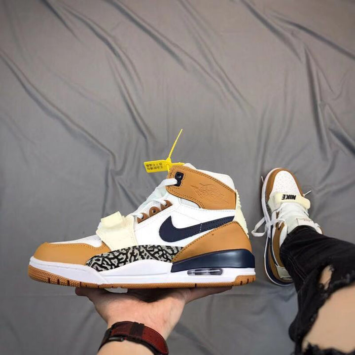 Air Jordan Legacy 312 sneaker shown from the side in white, tan, navy and gray patterned panels