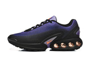 Side profile of a black Nike sneaker with purple upper and orange accent